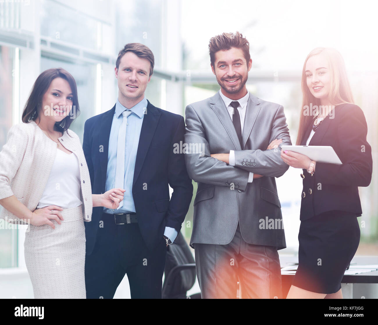 Casual business team smiling at camera together in the office Stock ...
