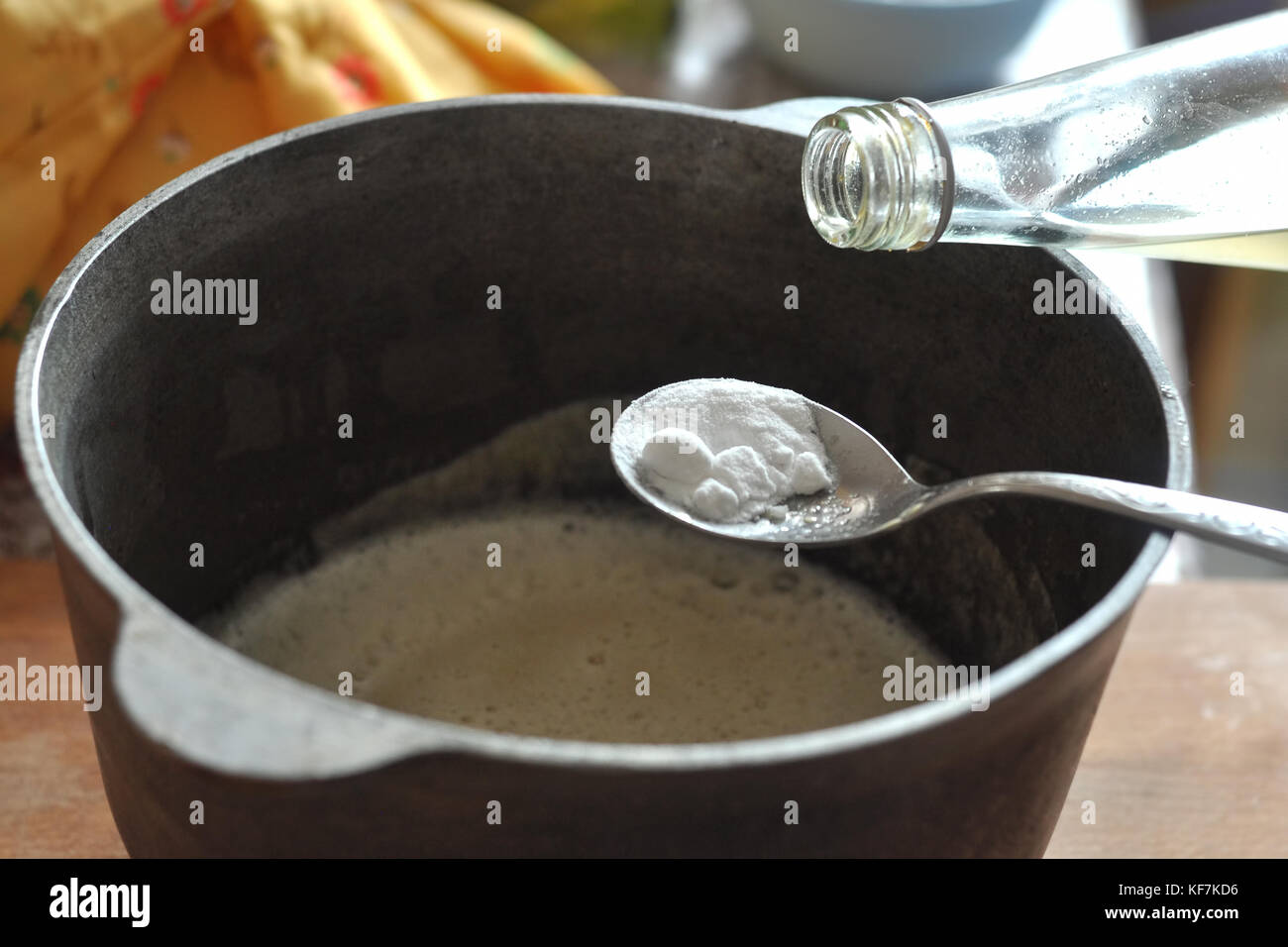 Process of quenching the baking soda with the vinegar in a spoon over a