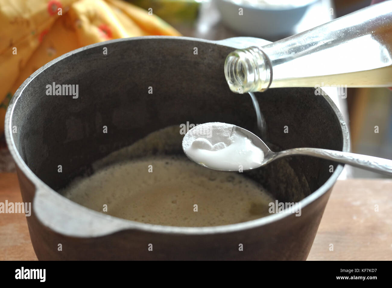 Process of quenching the baking soda with the vinegar in a spoon over a