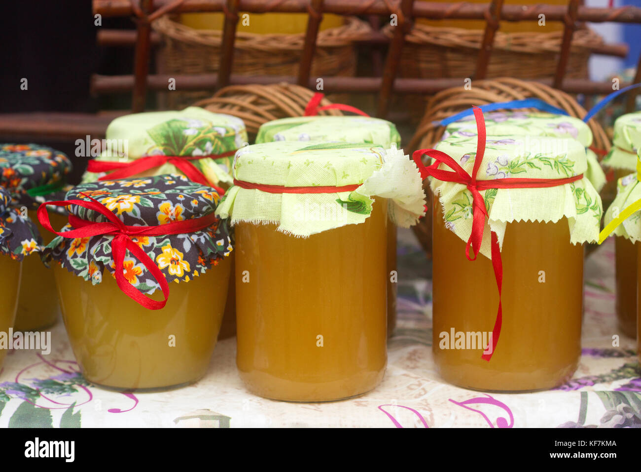 Honey in glass jars at an agricultural exhibition. Selective focus