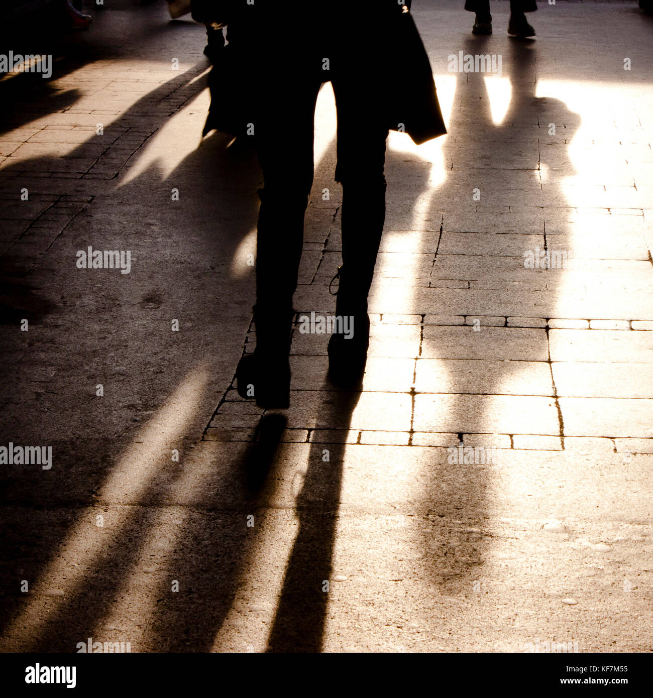 Blurry shadow and silhouette of people walking on the city street ...