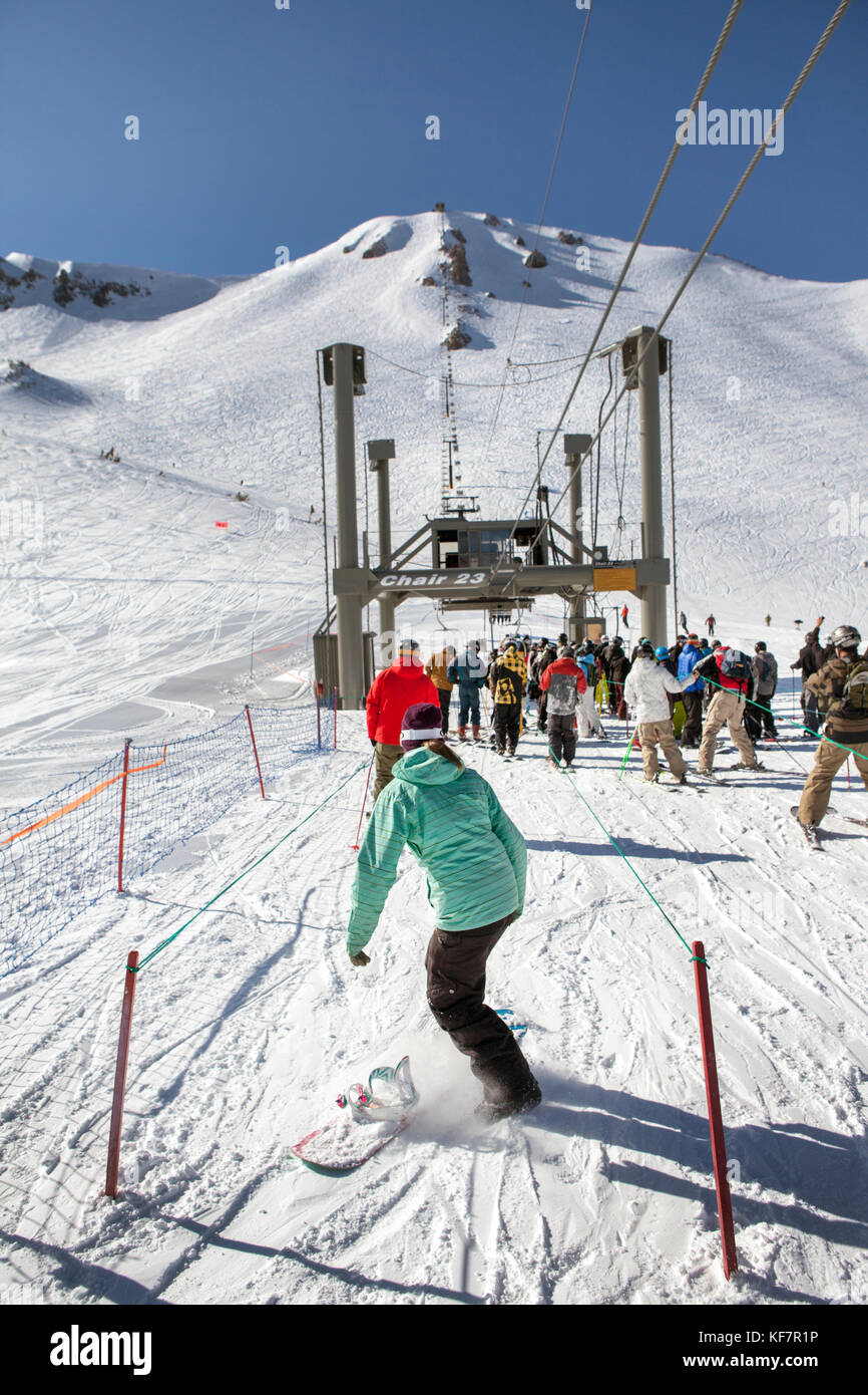 USA, California, Mammoth, skiers and snowboarders wait in line to ride ...