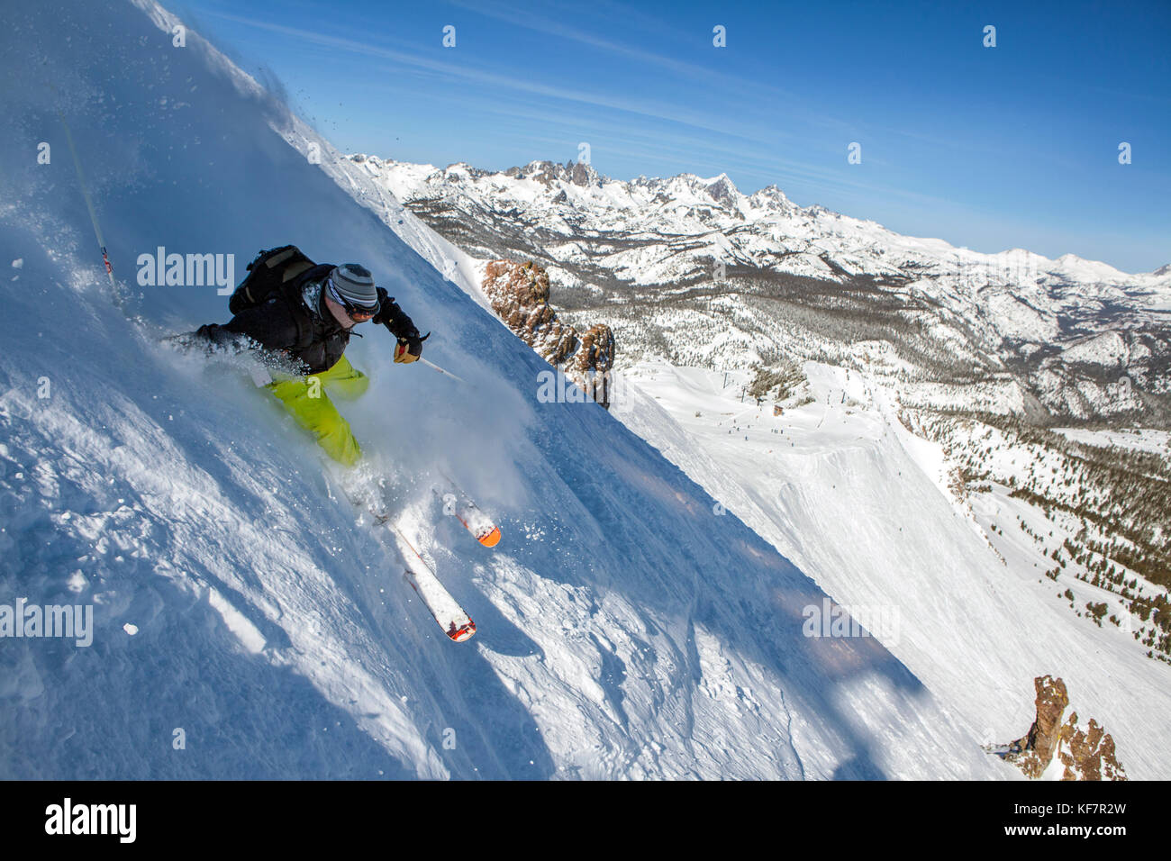 USA, California, Mammoth, a brightly colored skier carves his way down the run at Mammoth Ski Resort Stock Photo
