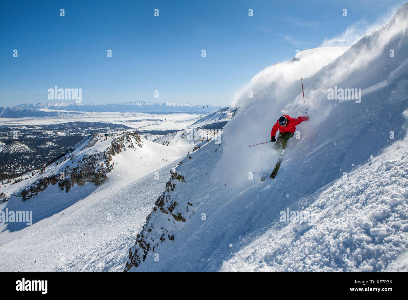 USA, California, Mammoth, a brightly colored skier carves his way down the run at Mammoth Ski Resort Stock Photo