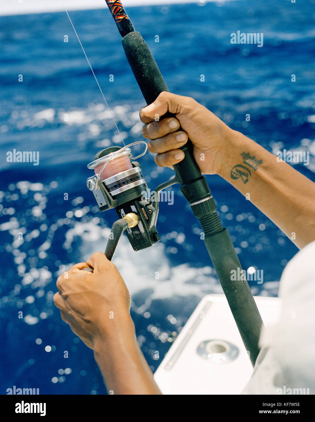 USA, Florida, man reeling fishing rod, close-up, Islamorada Stock