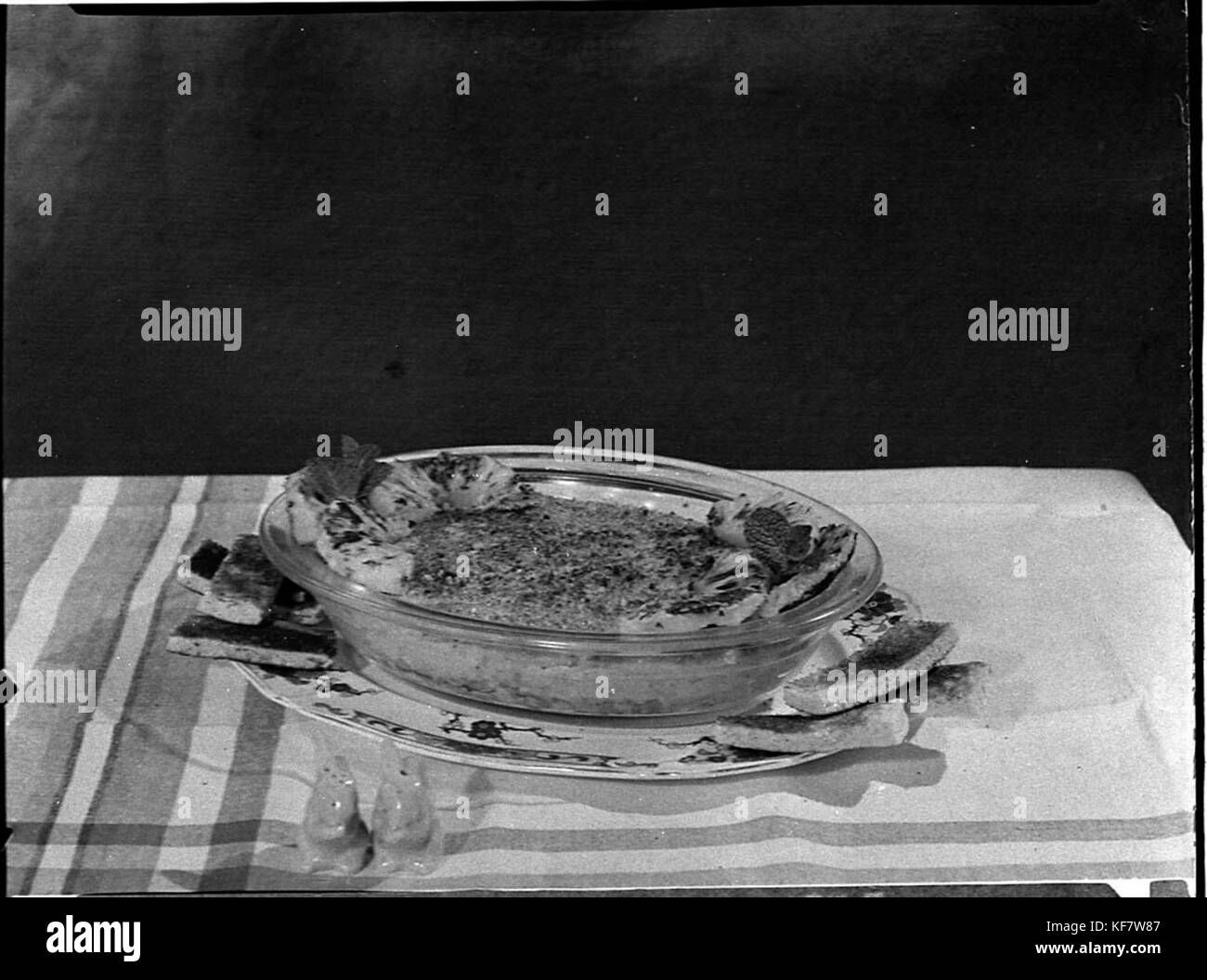 This image shows a cooking exhibition featured on the Smiths Weekly cooking page, showcasing various culinary techniques and food presentations. It reflects the early 20th century’s interest in food culture and innovation. Stock Photo