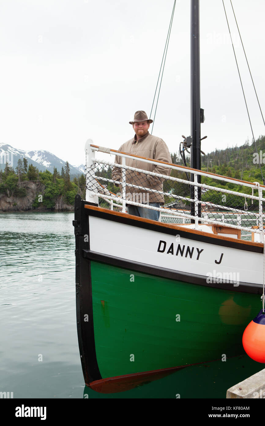 USA, Alaska, Homer, a boat captain stands on the bow of the Danny J boat, Halibut Cove Stock