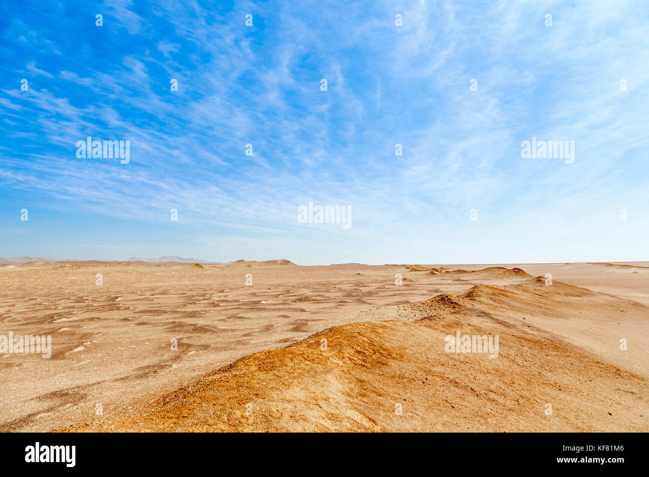 Blue sky with clouds and yellow sands of Paracas desert national park, Peru Stock Photo