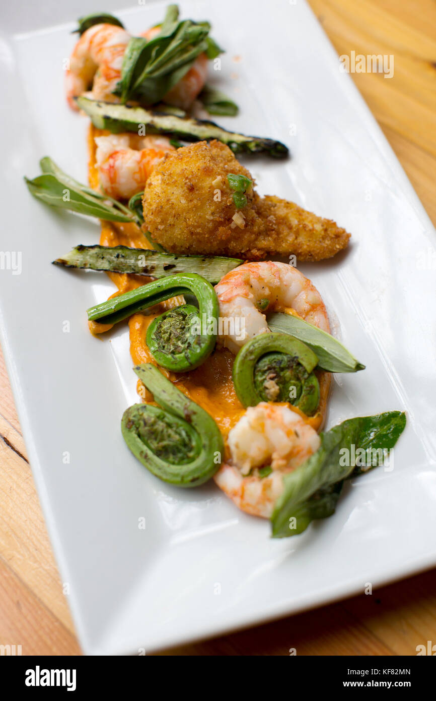 CANADA, Vancouver, British Columbia, shrimp and fiddlehead ferns are served at a local bistro, Edible Canada, located on Granville Island Stock Photo