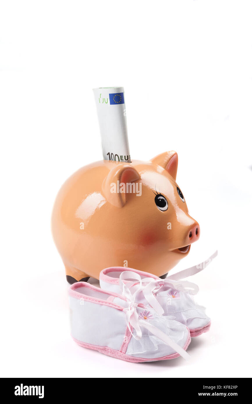 Piggy Bank With Newborn Baby Girl Shoes and 100 Euro Banknote Isolated