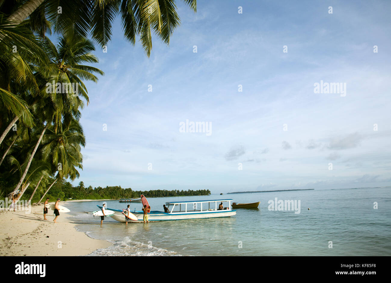 INDONESIA, Mentawai Islands, Kandui Surf Resort, surfers loading a boat to go surfing Stock Photo