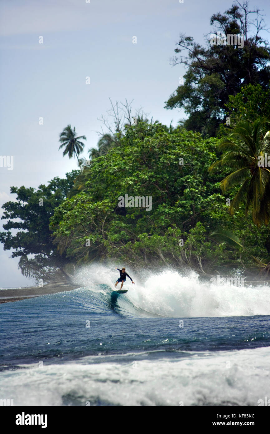 INDONESIA, Mentawai Islands, Kandui Resort, a man surfing a wave, Nupssy Stock Photo