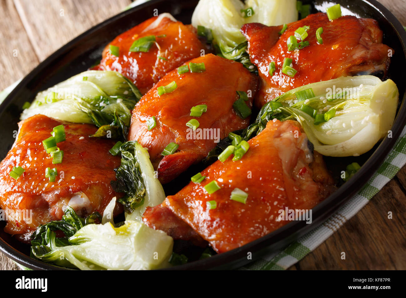 Fried chicken thighs with pak choy, ginger, garlic and green onions