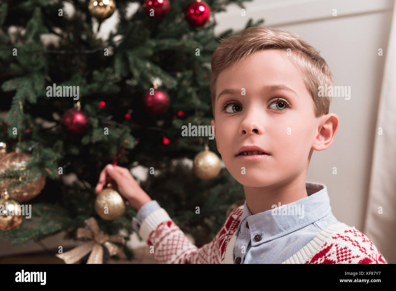 boy decorating christmas tree Stock Photo Alamy