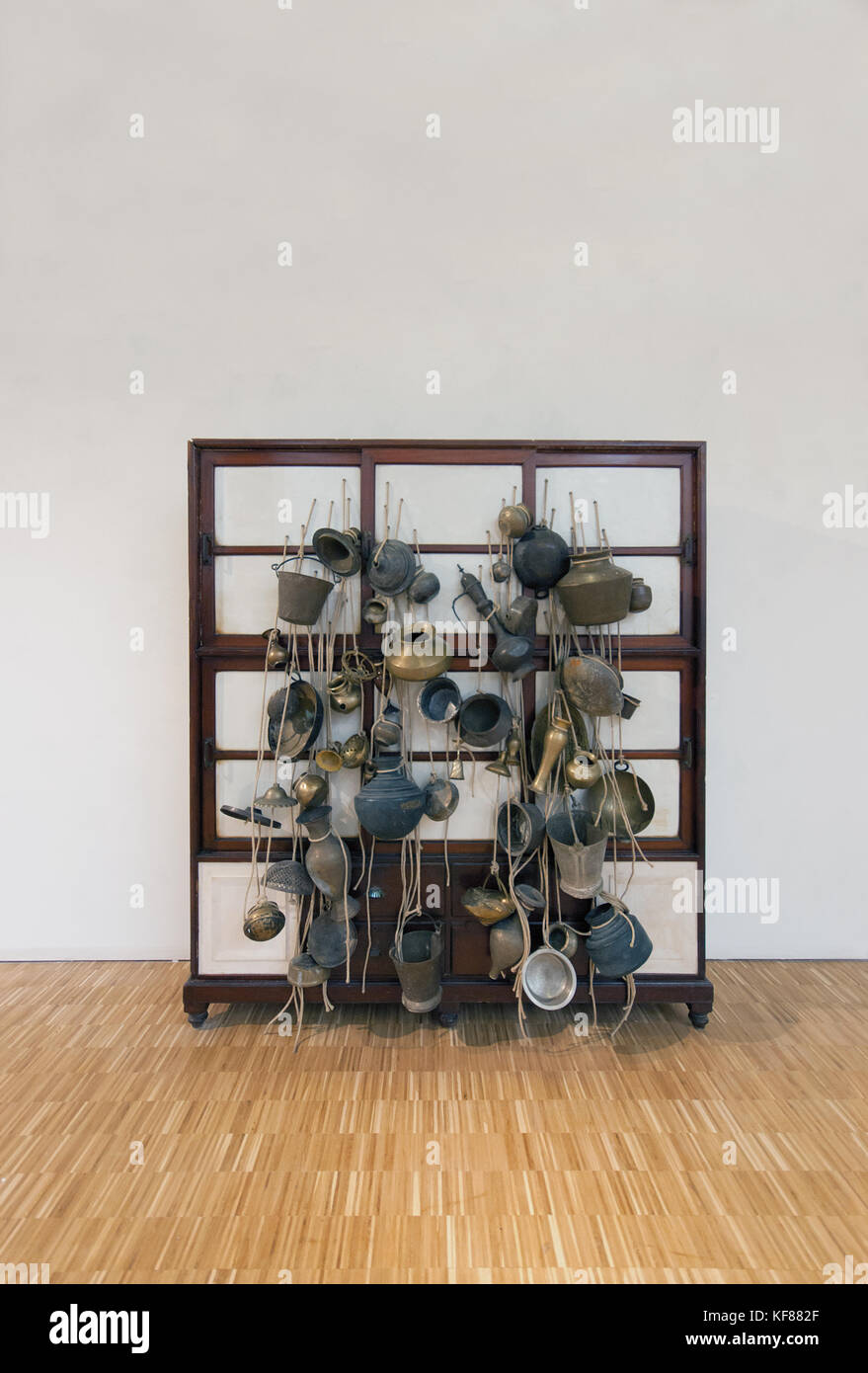 Subodh Gupta, Ancestor Cupboard, 2012,Wooden cabinet, utensils, plaster, jute robe, fiberglass; 'Arts and Foods' exhibition, Milan Triennale, 2015 Stock Photo