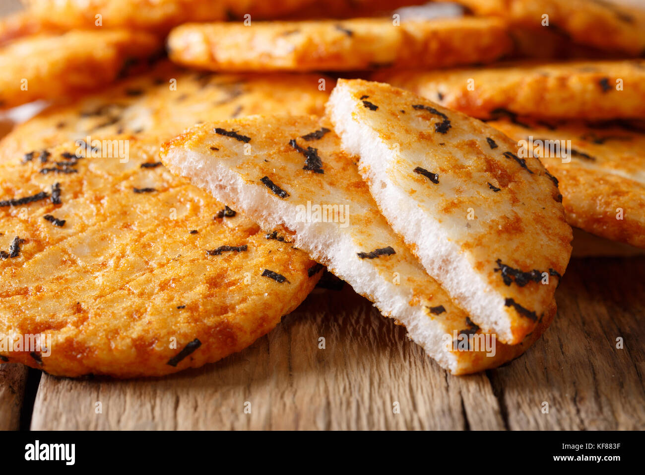 Japanese appetizer rice cakes with seaweed macro on the table