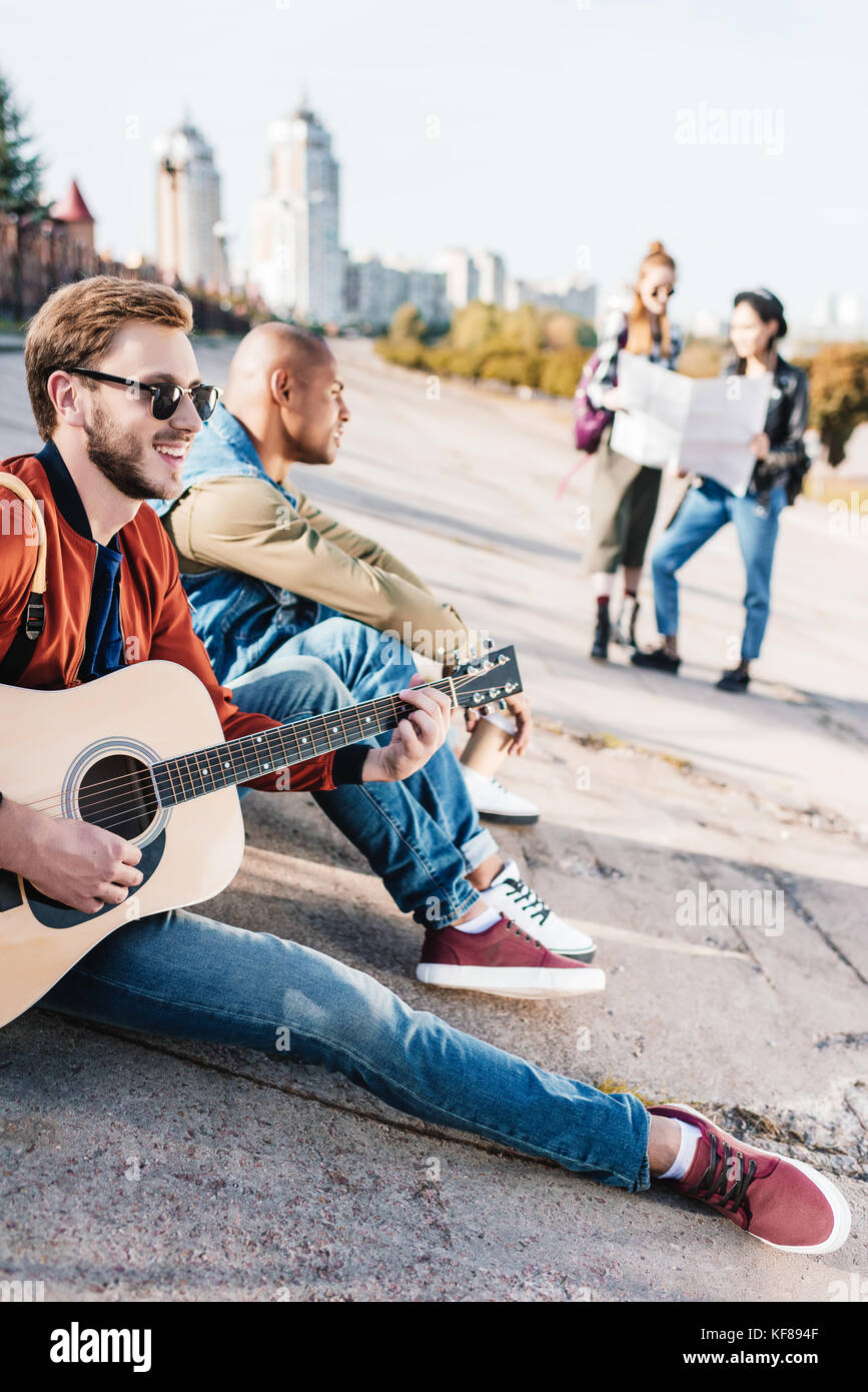 multicultural friends with guitar Stock Photo - Alamy