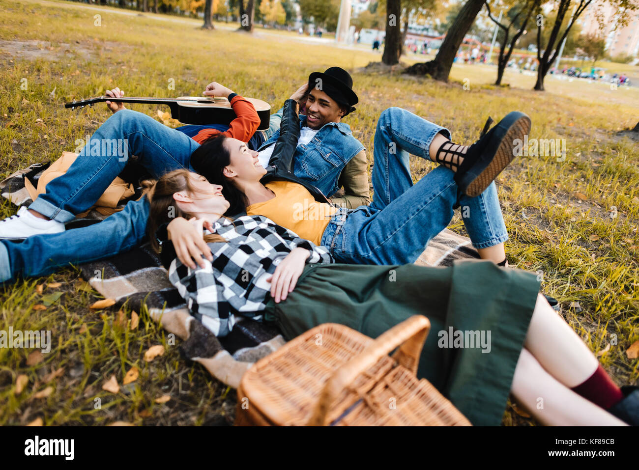 multicultural friends resting in park Stock Photo - Alamy