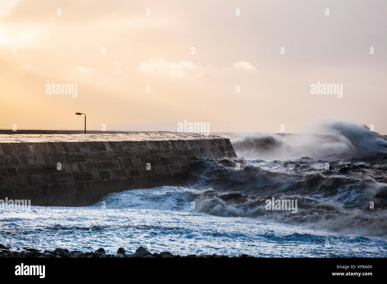 Waves crash over the Cobb at Lyme Regis in Dorset during Storm Brian on Saturday 21st October 2017. Stock Photo
