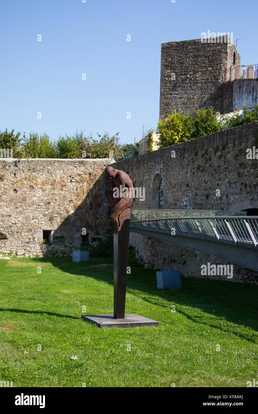 Old city walls and modern art sculpture, Guardiao I or Guardian I, by Rogerio Timoteo, Portalegre, Portugal Stock Photo