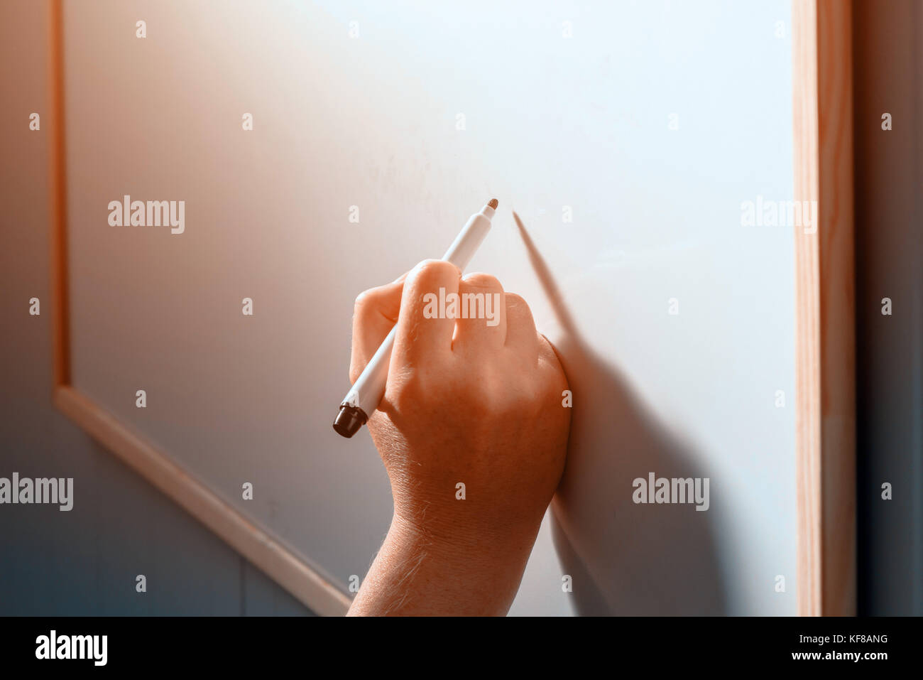 Female businessperson writing on office whiteboard during business
