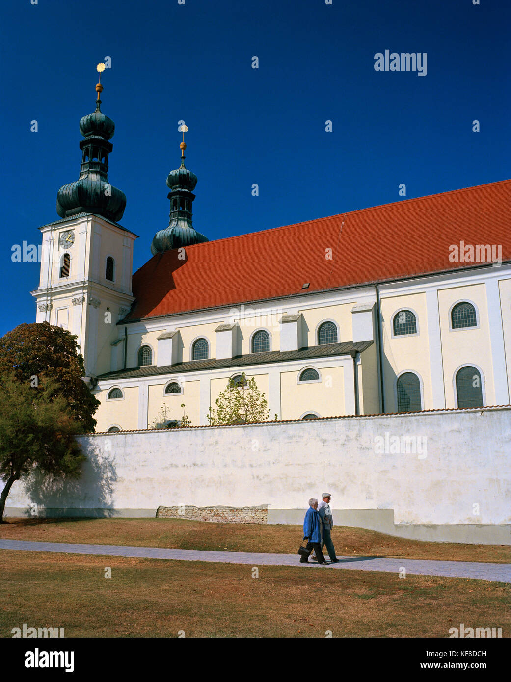 AUSTRIA, Frauenkirchen, people walk in front of the Basilica Baroque Church, Burgenland Stock Photo