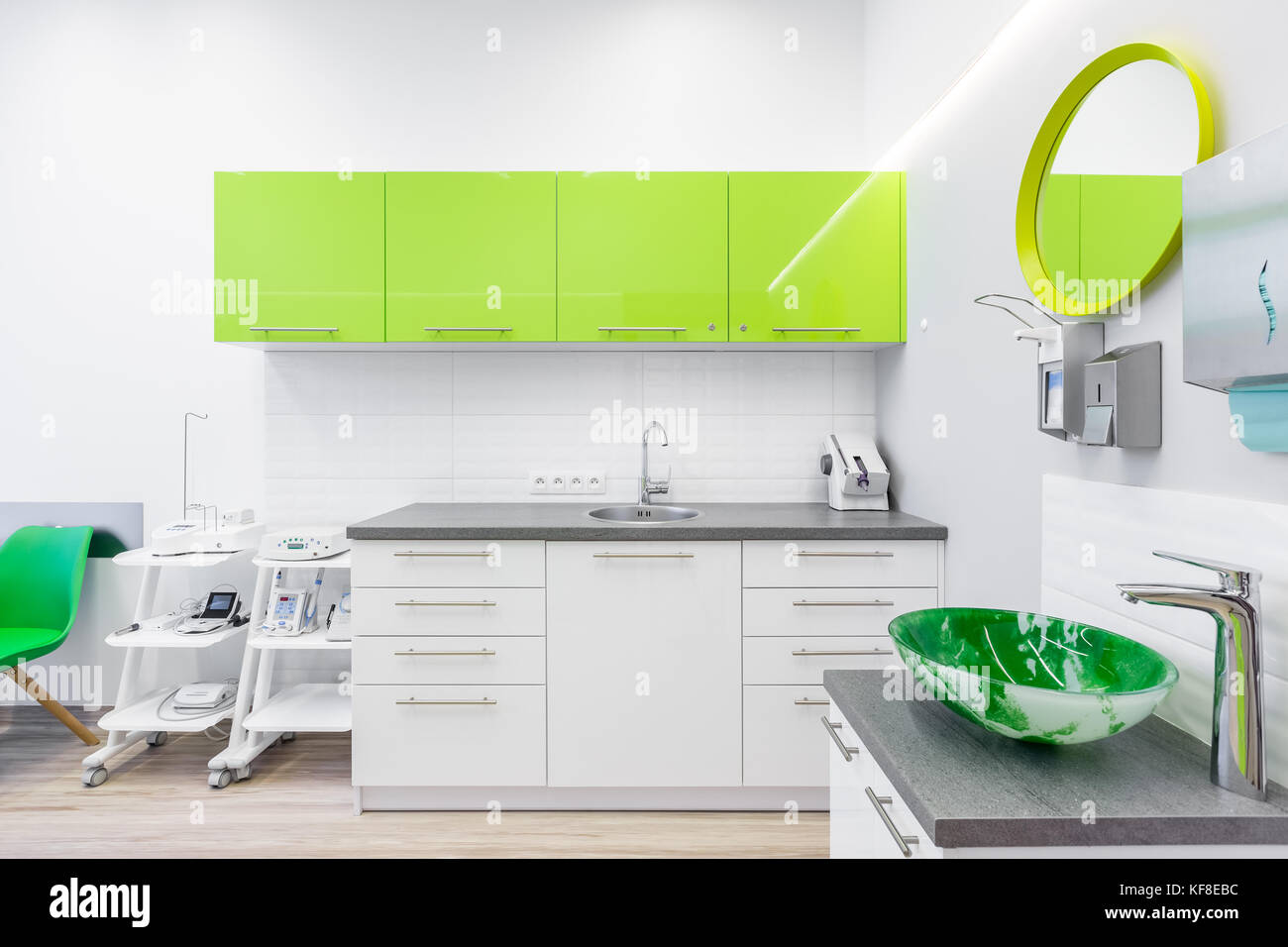 Modern interior of dentistry clinic with lime cabinets Stock Photo - Alamy
