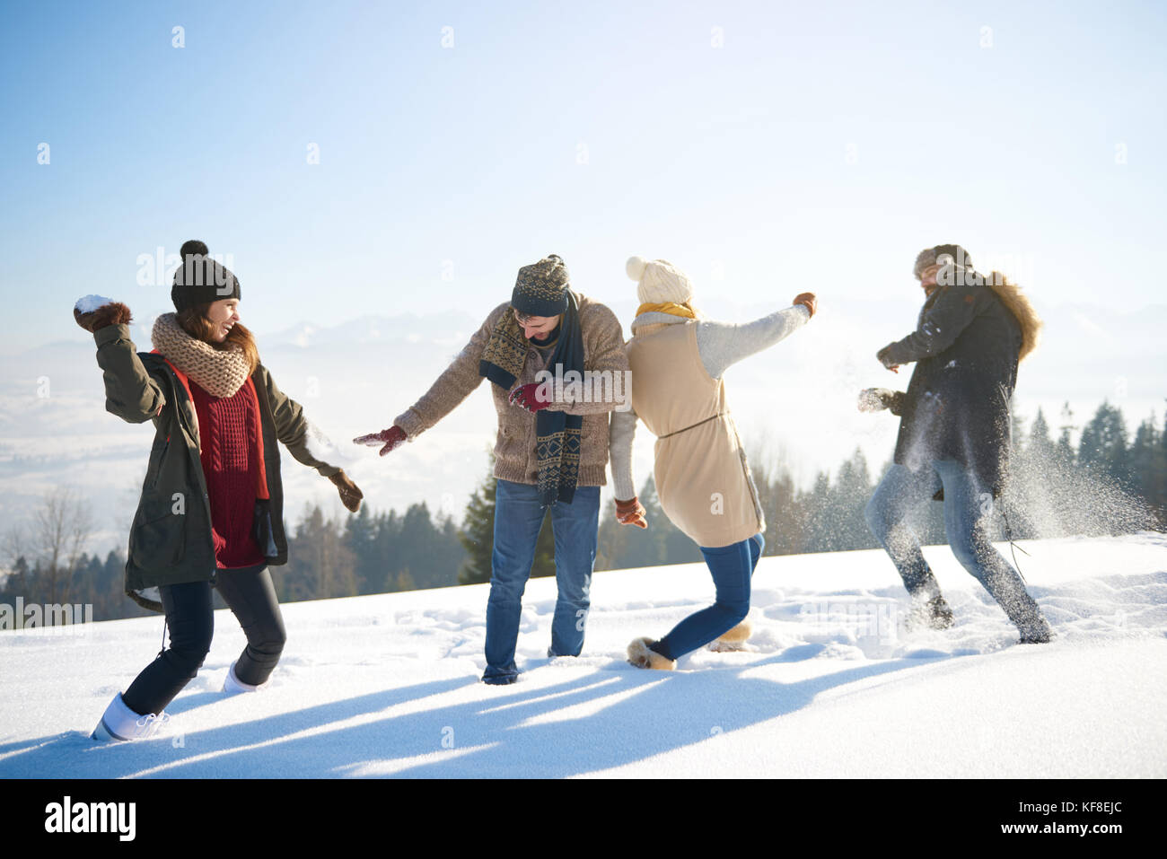 Friends having a funny snow fight Stock Photo