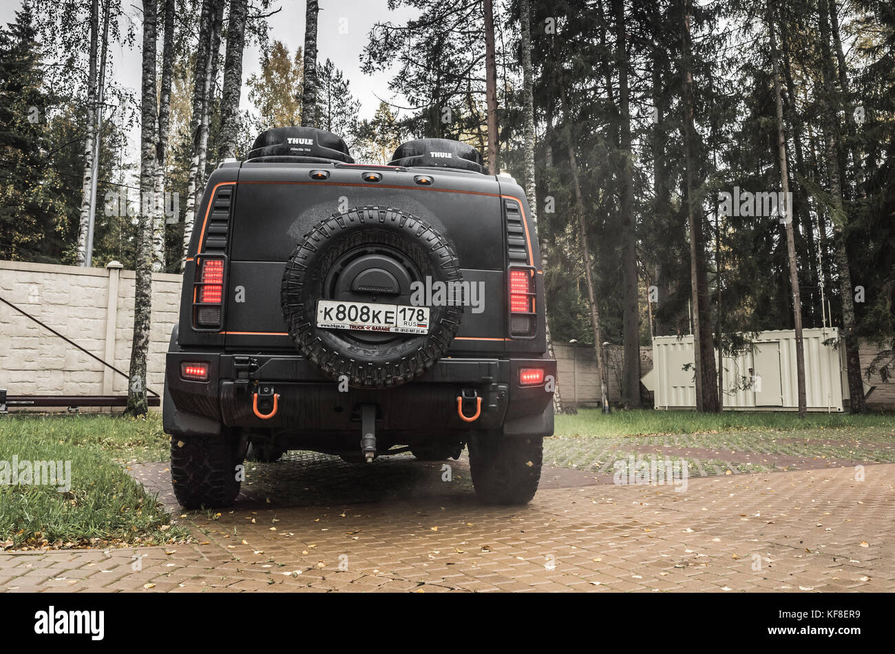 Saint-Petersburg, Russia - October 8, 2017: Black Hummer H2 car stands on rural parking lot in Russian countryside, back side Stock Photo