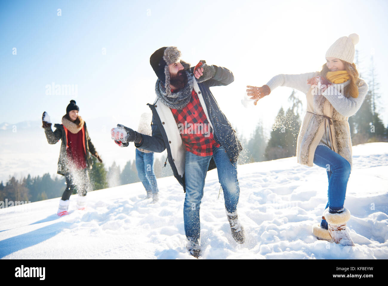 Cheerful couple playing in the snow Stock Photo - Alamy
