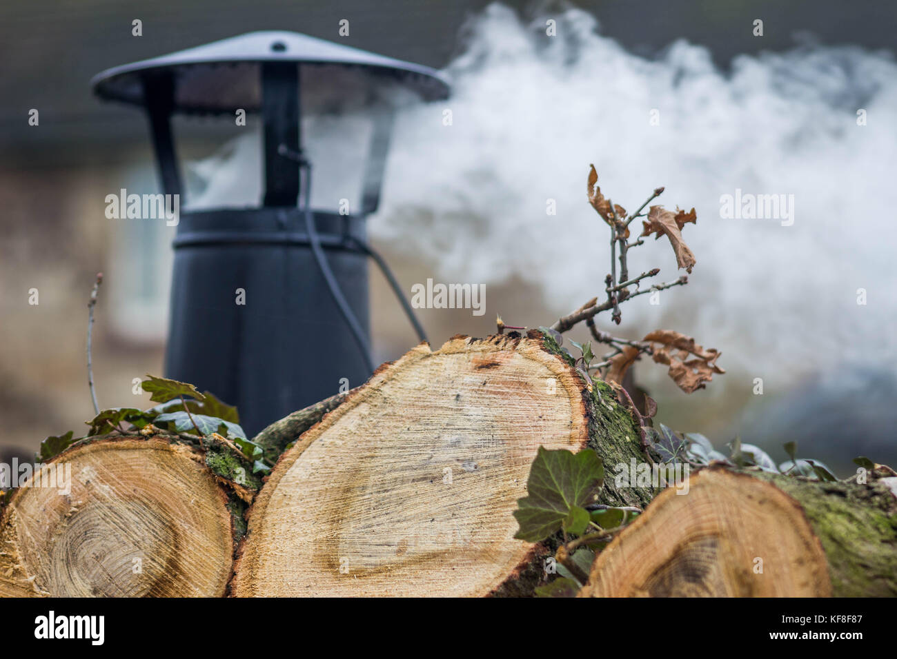A smoking chimney pot attached to a log burning/ multi fuel stove Stock Photo Alamy