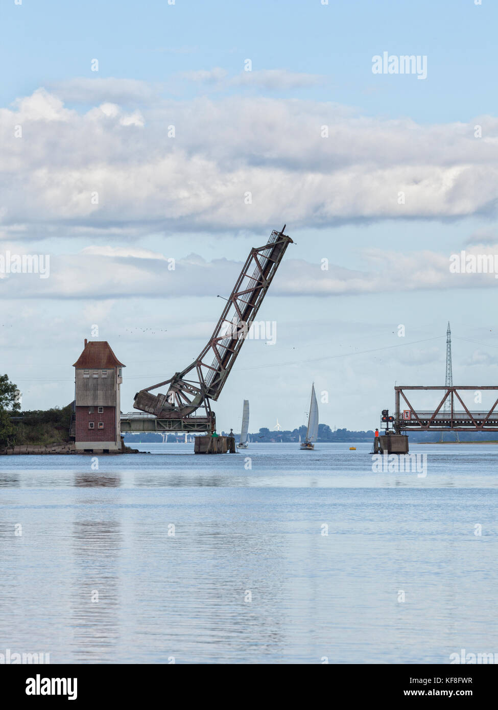 Sailboats passing the open draw bridge across Schlei inlet at Lindaunis Stock Photo