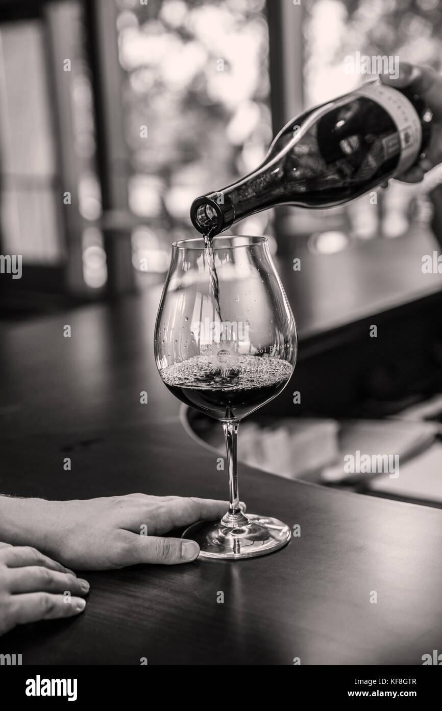 USA, Oregon, Willamette Valley, a glass of wine being poured at the tasting room bar, Sokol Blosser Winery, Dayton Stock Photo