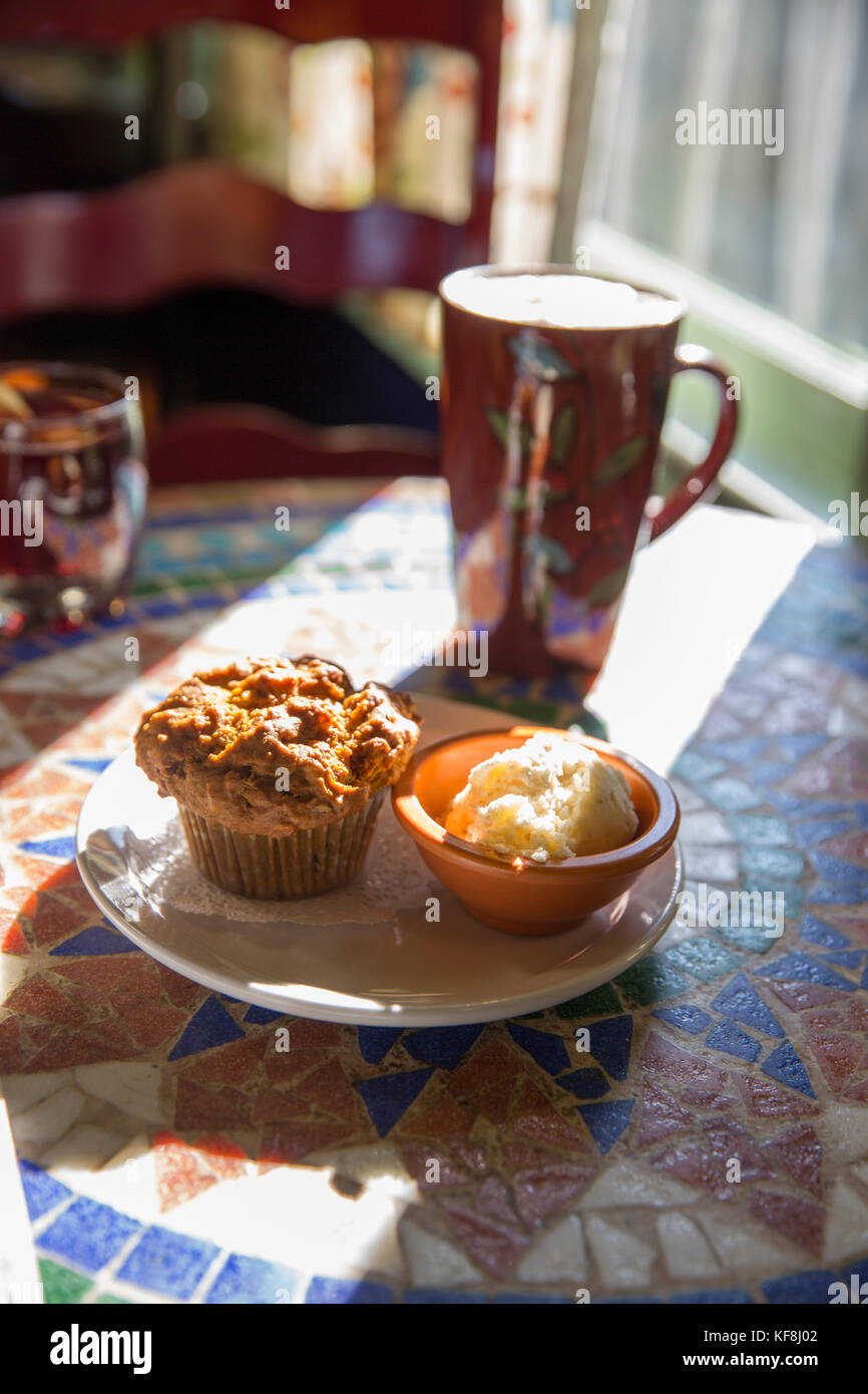 USA, Oregon, Ashland, interior table detail at the colorful Morning Glory Restaurant on Siskiyoui Blvd during breakfast, pumpkin oat muffin served wit Stock Photo