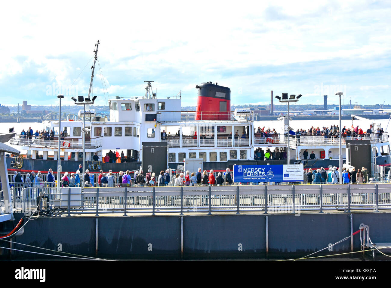 Liverpool Mersey Ferries Royal Iris of The Mersey at  Pier Head with crowds of people waiting to disembark & many others wait to board England UK Stock Photo