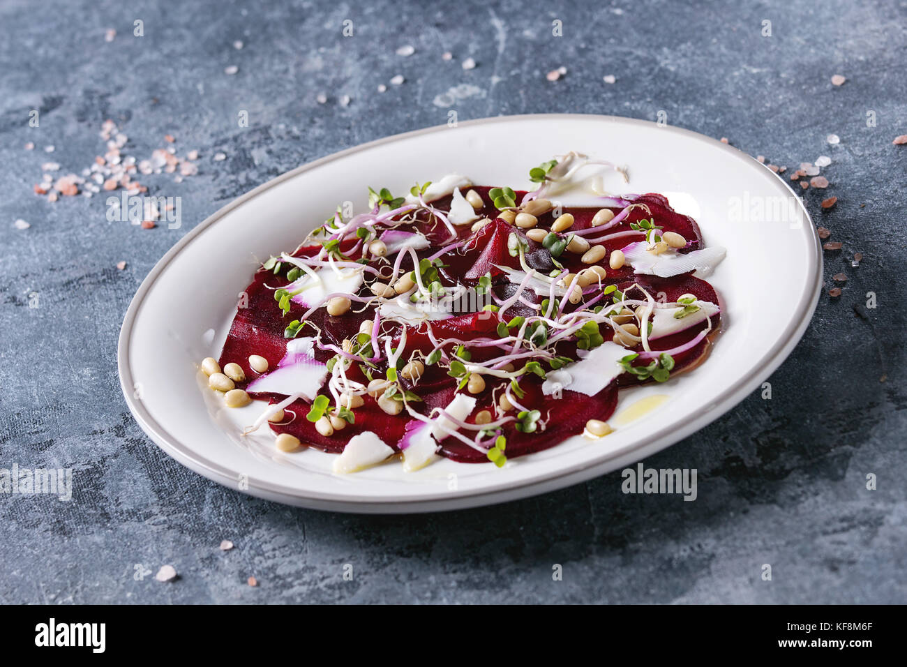 Vegetarian beetroot carpaccio salads with olive oil, goat cheese, pine