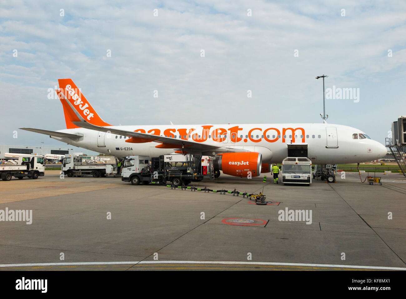 Refuelling between flights, Airbus A320 plane number G-EZOA operated by Easyjet refuels from underground tank on apron at Gatwick airport, London. UK Stock Photo