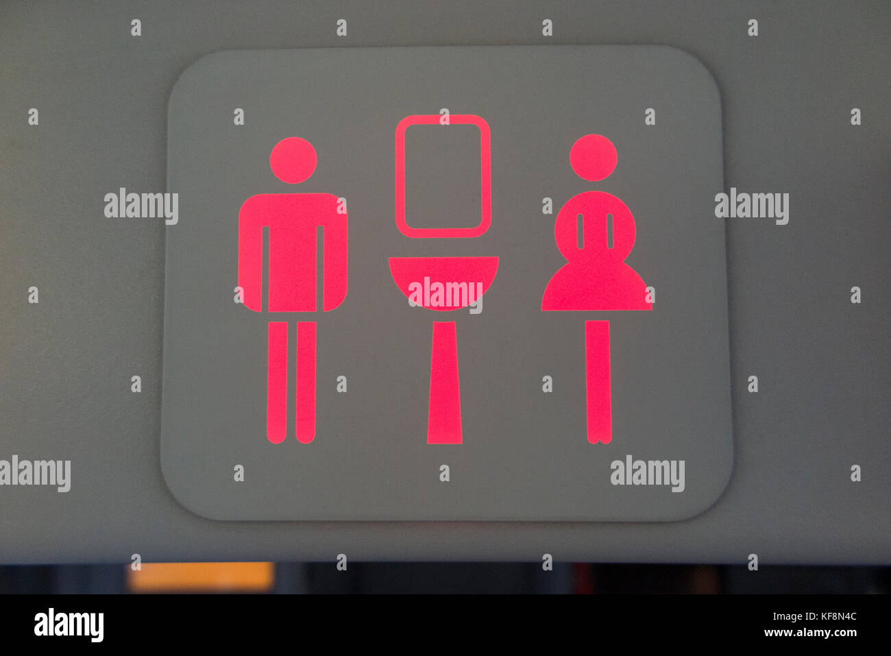 Toilet toilets sign / lavatory / loo / WC / ladies / gents / logo signs on an Airbus A320-214 airplane / Air plane / aeroplane / aircraft. (91) Stock Photo