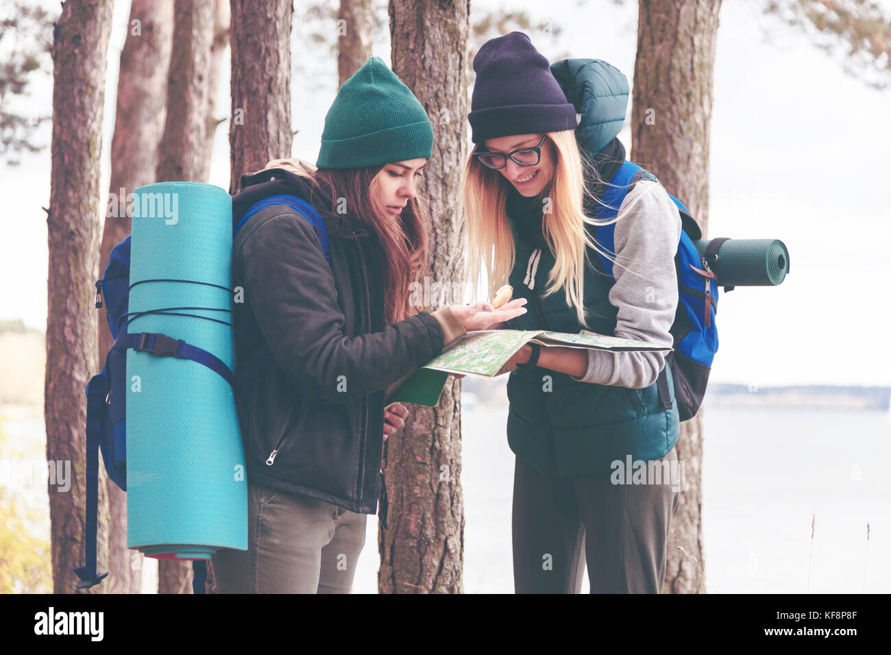 Two young tourist determine the route map and compass. Stock Photo