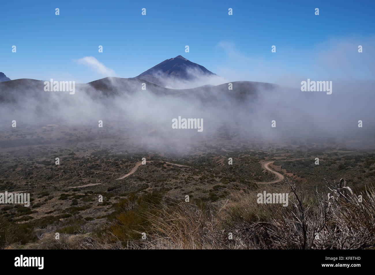 The peak of Mount Teide rising above low cloud. Teide National Park, Tenerife, Canary Islands, Spain. Stock Photo