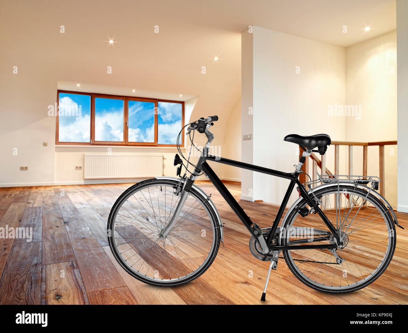 Modern interior with wooden floor and Bike in foreground Stock Photo