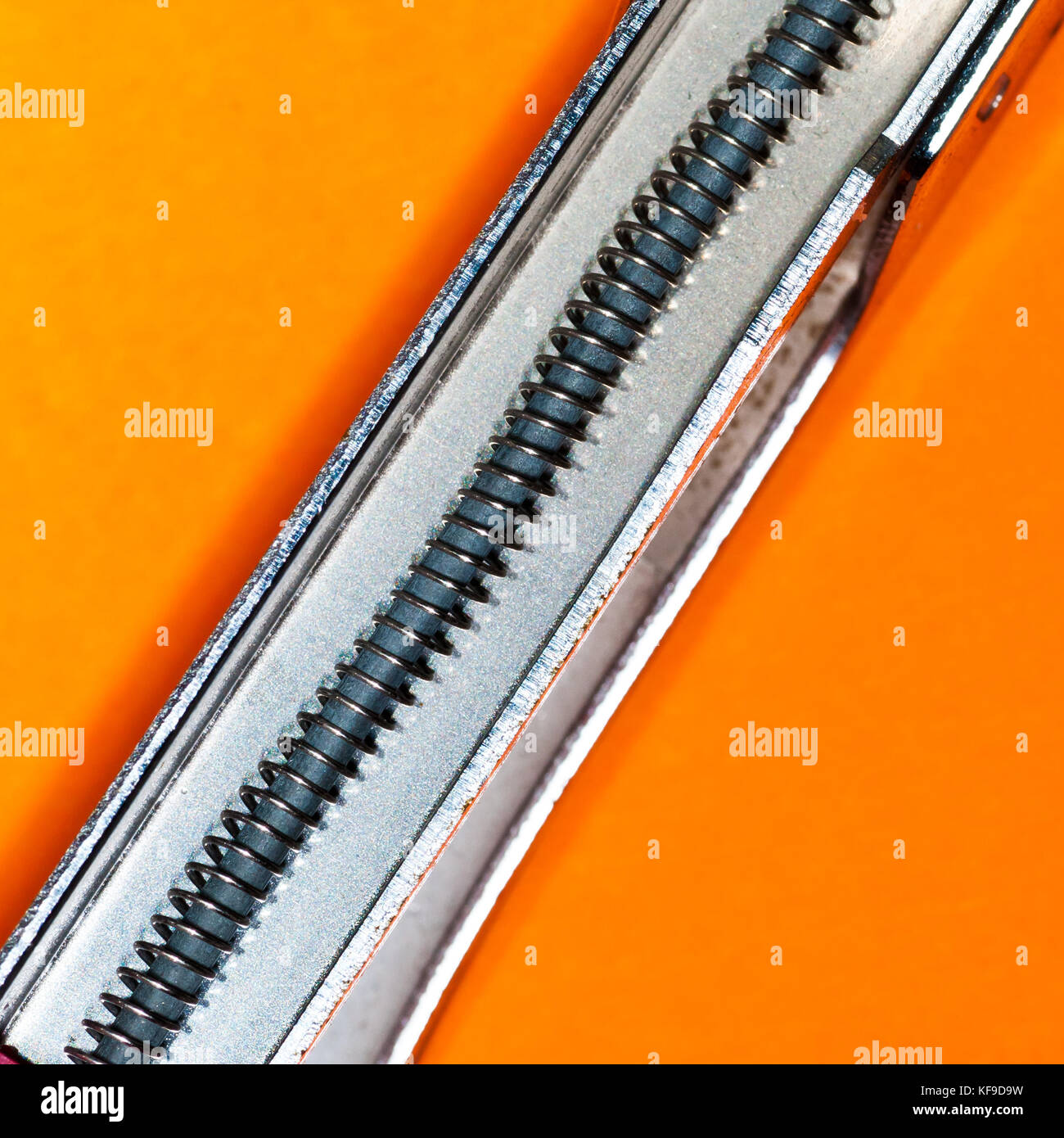 A macro shot of the spring inside a stapler. Stock Photo