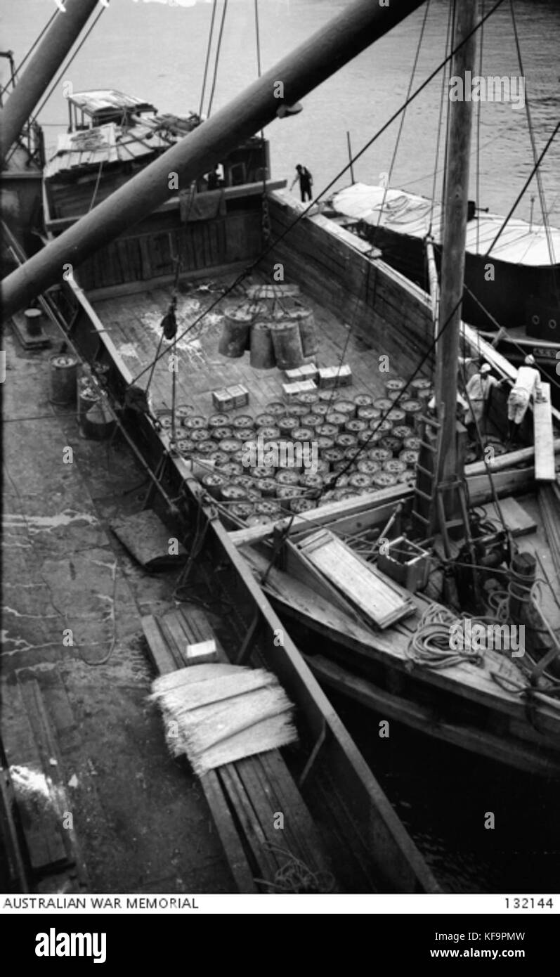 132144 WOODEN LIGHTERS CARRYING MUSTARD GAS CONTAINERS MOORED ALONGSIDE THE SHIP SHINTONMARU Stock Photo