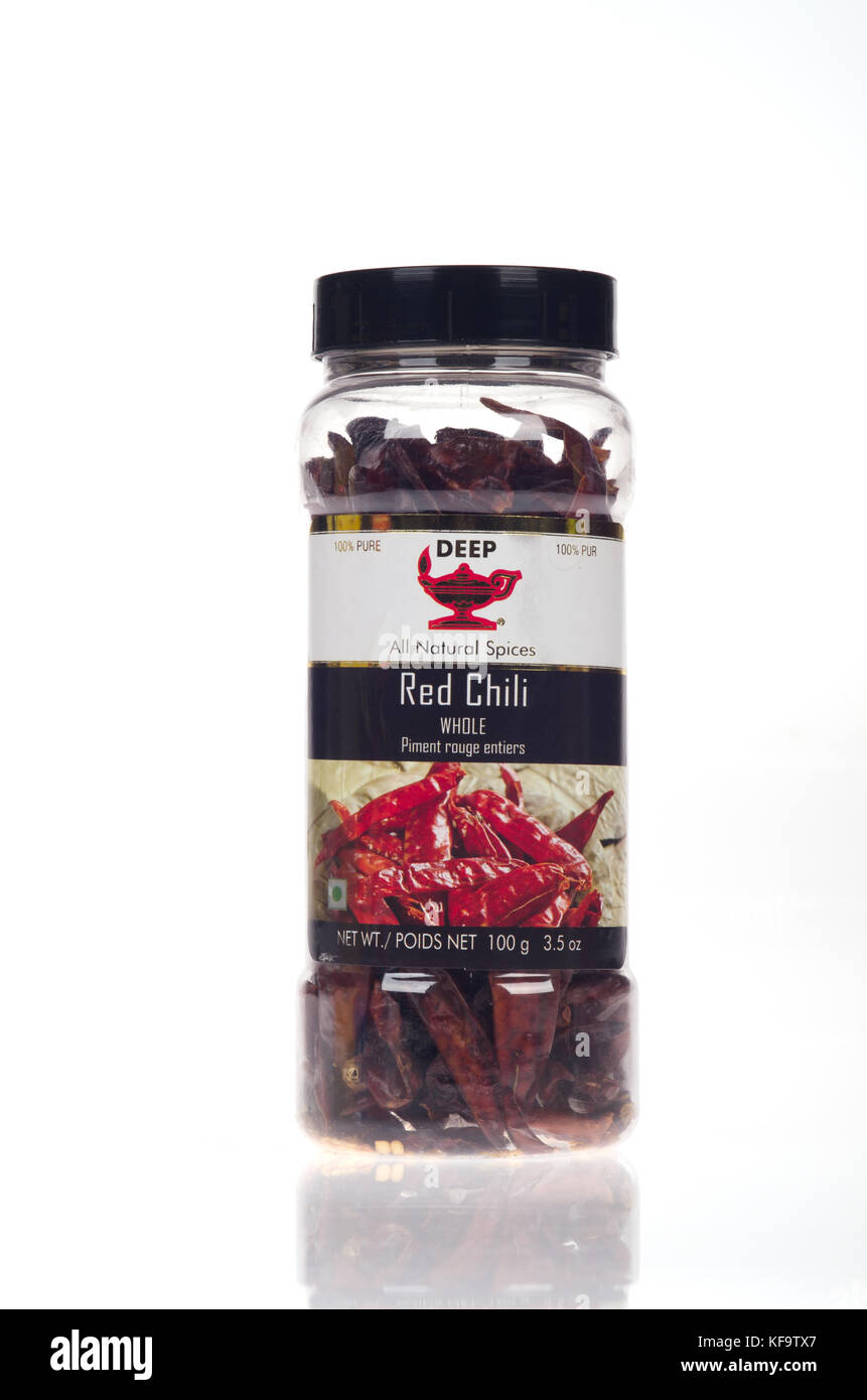 Container of Deep indian dried red chili pods Stock Photo