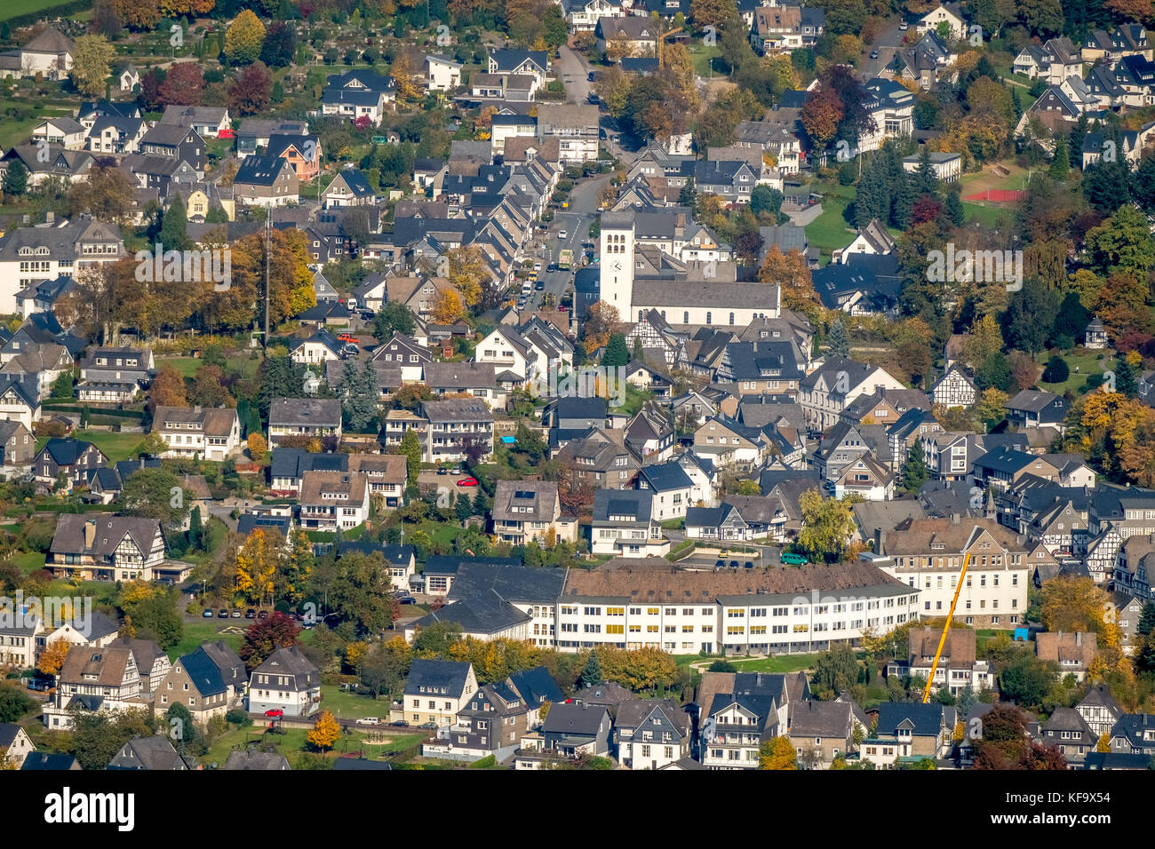 View of Bad Fredeburg Catholic church of St George, medical care center, street in Ohle, Golden October, indian summer, Schmallenberg, Sauerland, Nort Stock Photo
