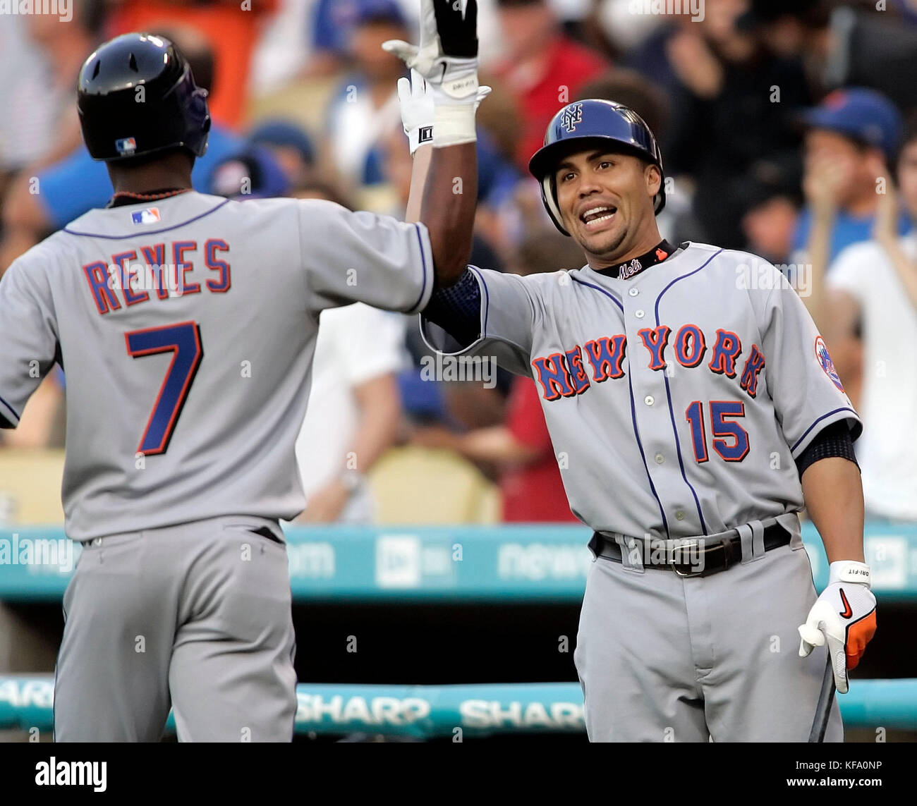 New York Mets' Jose Reyes, left, is greeted by teammate Carlos Beltran ...