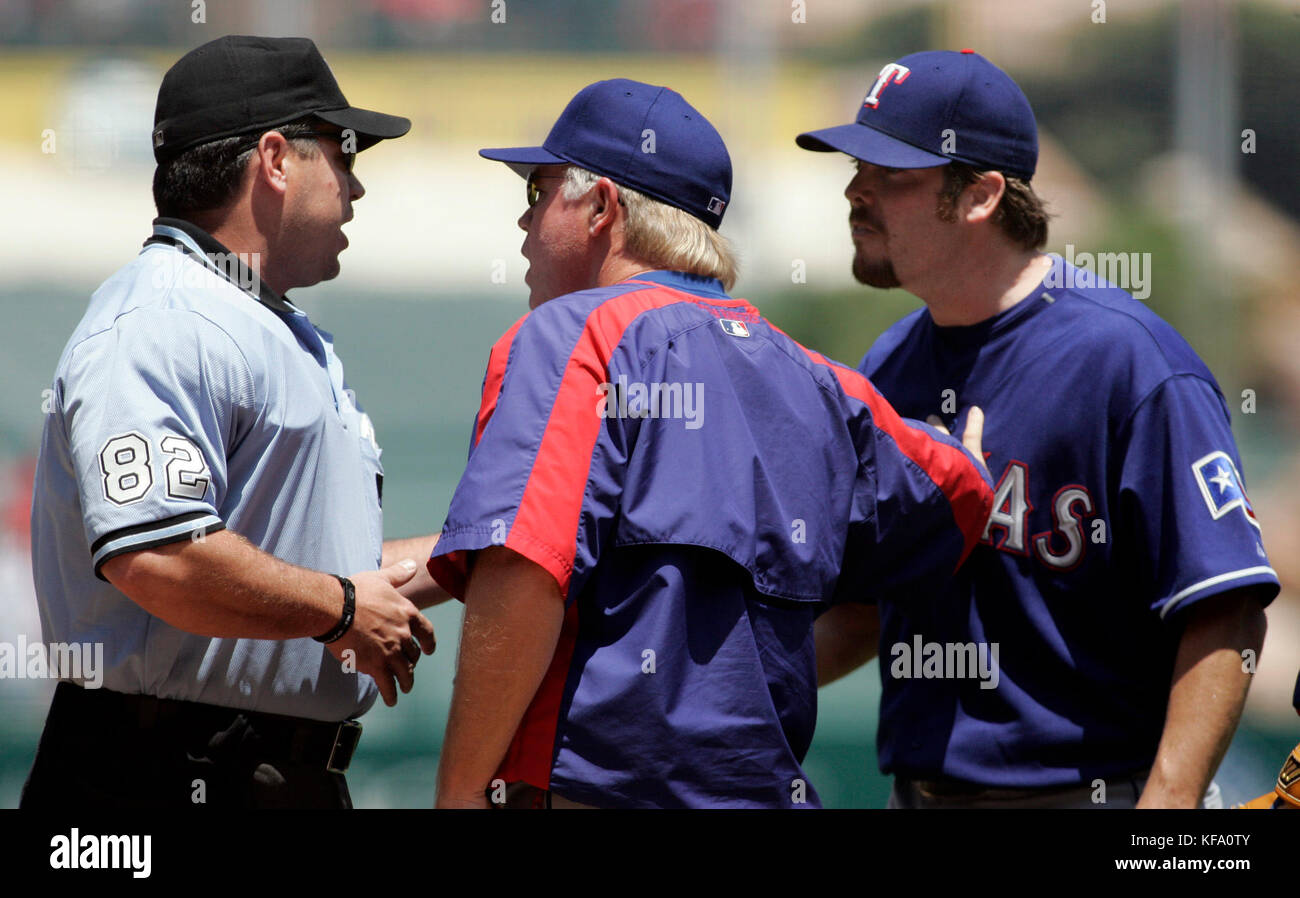 Texas Rangers manager Buck Showalter, center, holds back pitcher Adam Eaton, right, after he was ejected from the game by home plate umpire Rob Drake in the first inning of a baseball game against the Los Angeles Angels in Anaheim, Calif., on Sunday, Aug. 6, 2006. Photo by Francis Specker Stock Photo