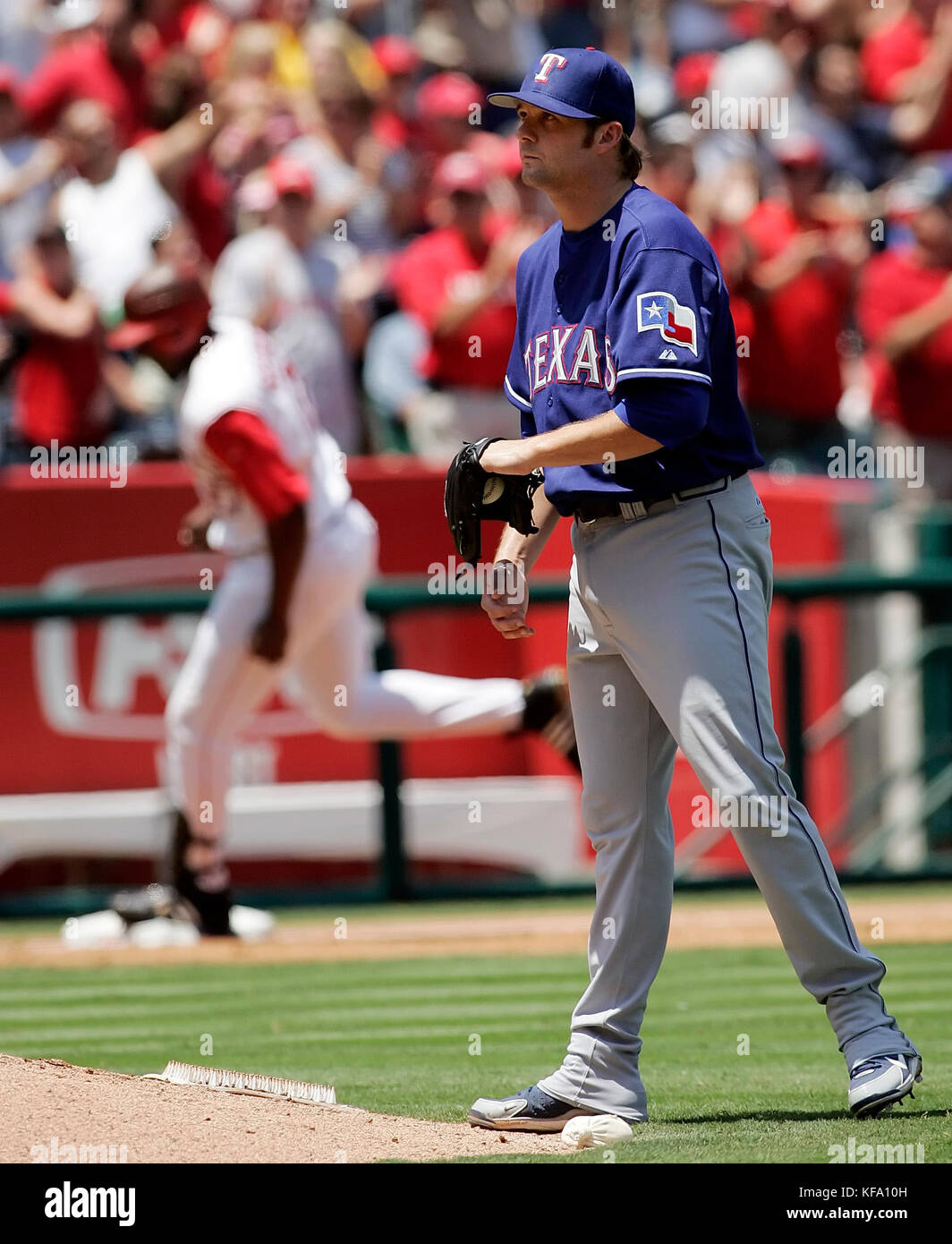 Los Angeles Angels' Garret Anderson, left, is greeted at home by teammate  Vladimir Guerrero after he hit a three-run homer off Texas Rangers pitcher  Adam Eaton in the first inning of a