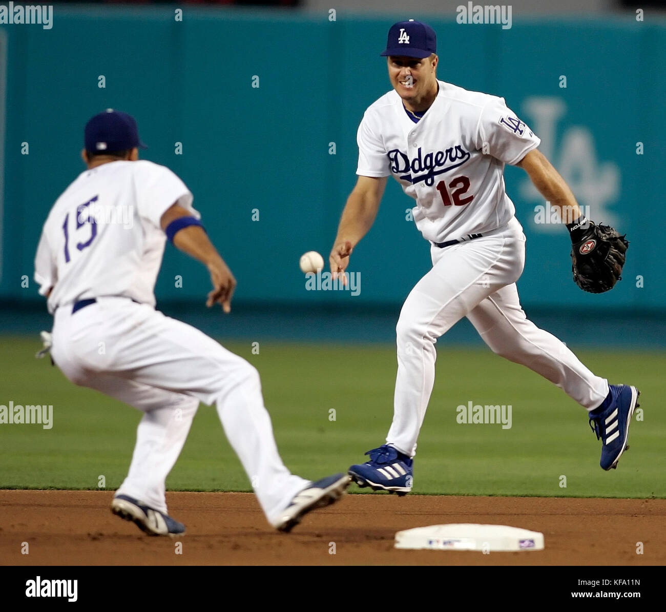 Los Angeles Dodgers second baseman Jeff Kent, right, tosses the ball to  shortstop Rafael Furcal to force out Colorado Rockies' Matt Holliday (not  pictured) at second base in the first inning of