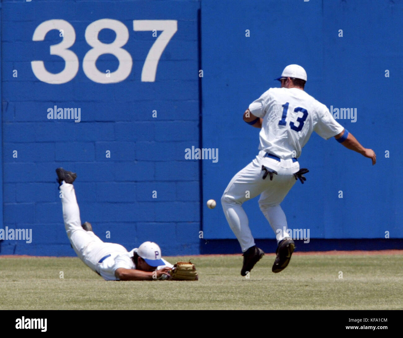 Pepperdine's leftfielder Brandon Daguio, left, and teammate Jason Durbin try to catch a fly ball
